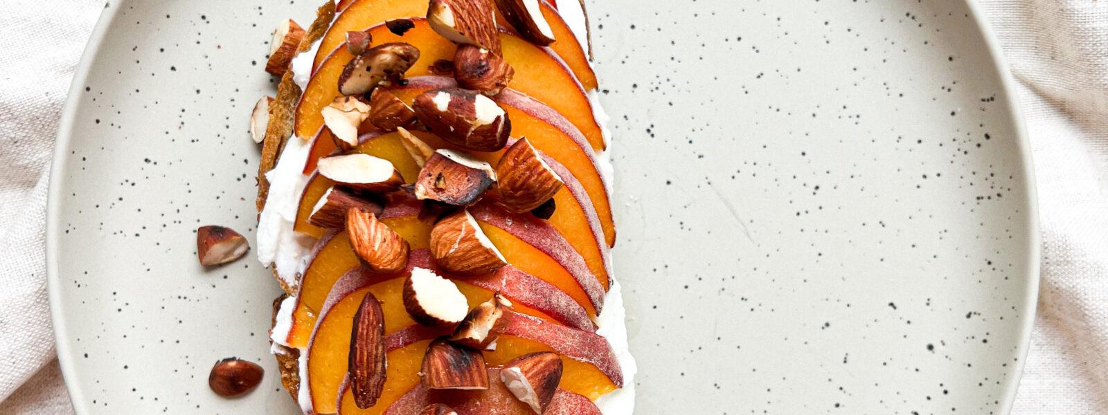 Tost z labnehem, grillowaną brzoskwinią i prażonymi migdałami